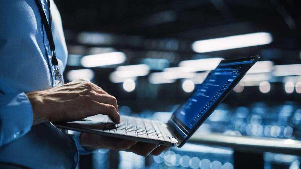man holding laptop