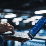man holding laptop